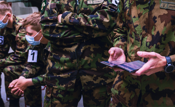 Picture of soldiers using contact tracing app