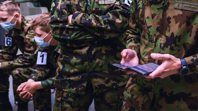 Picture of soldiers using contact tracing app